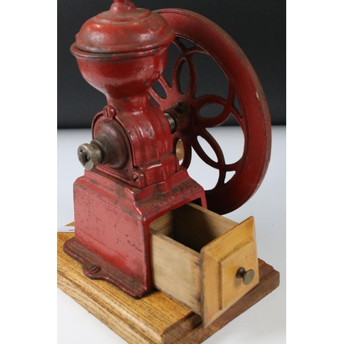 175 - Early to Mid 20th century Red Cast Iron ' National ' Coffee Grinder mounted on a wooden base, 23cm h... 