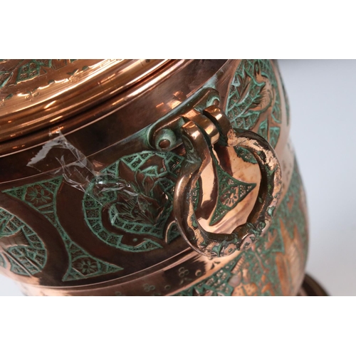 183 - Copper Lidded Urn with engraved Persian / Zoroastrian type decoration, two ringed handled, 35cm high