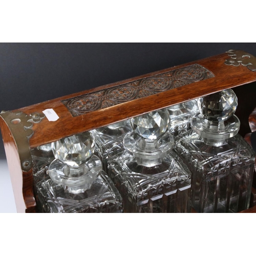 187 - Late 19th century Oak Cased and Brass mounted Tantalus holding three matching cut glass decanters an... 