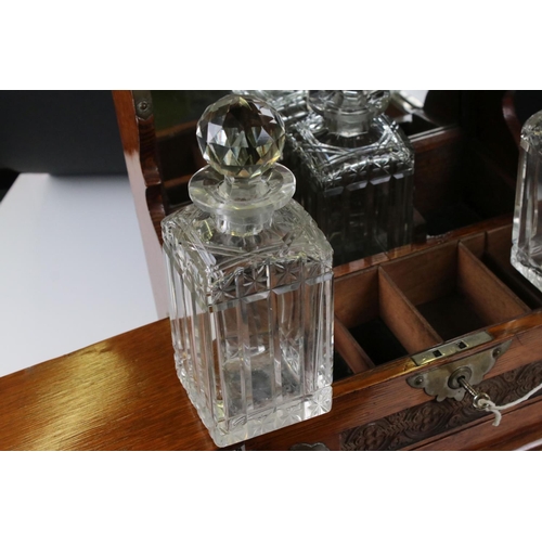 187 - Late 19th century Oak Cased and Brass mounted Tantalus holding three matching cut glass decanters an... 