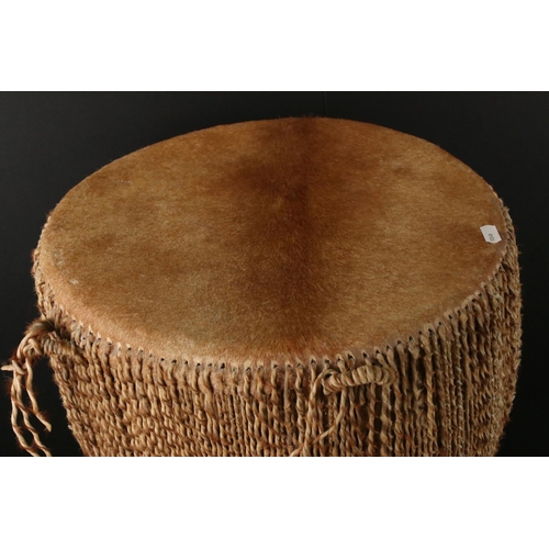 439 - African cowhide bongo drum with twine fastenings, 47cm high, together with a small African beadwork ... 