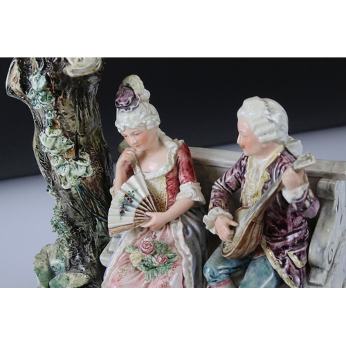 55 - 19th Century porcelain figural spill vase of a 19th Century courting couple on bench with tree, rais... 