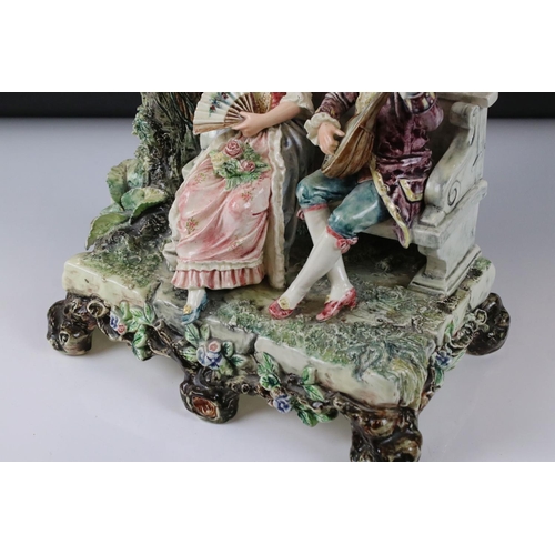 55 - 19th Century porcelain figural spill vase of a 19th Century courting couple on bench with tree, rais... 