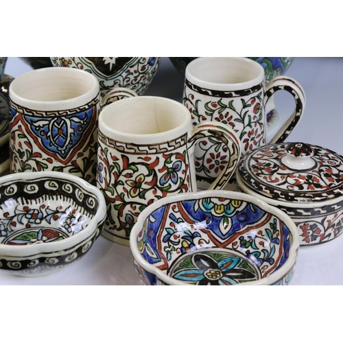 58 - Collection of Persian Islamic / Iznik Pottery including Two Water Jugs, 32cm high Vase, Three Mugs, ... 