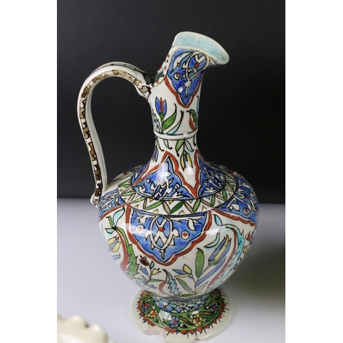 58 - Collection of Persian Islamic / Iznik Pottery including Two Water Jugs, 32cm high Vase, Three Mugs, ... 