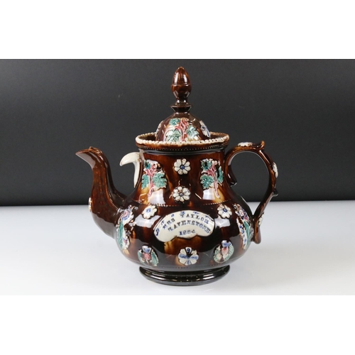 71 - Victorian Bargeware Teapot inscribed ' Mrs Taylor, Ravenstone 1884 ', with applied floral decoration... 