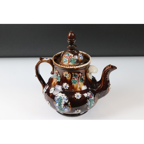 71 - Victorian Bargeware Teapot inscribed ' Mrs Taylor, Ravenstone 1884 ', with applied floral decoration... 