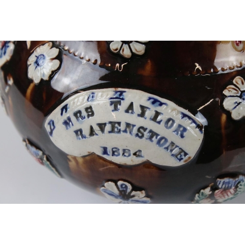 71 - Victorian Bargeware Teapot inscribed ' Mrs Taylor, Ravenstone 1884 ', with applied floral decoration... 