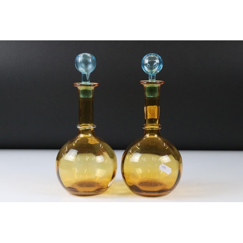 85 - Pair of Early 20th century Amber Glass Decanters with Blue Glass Stoppers, 27cm high