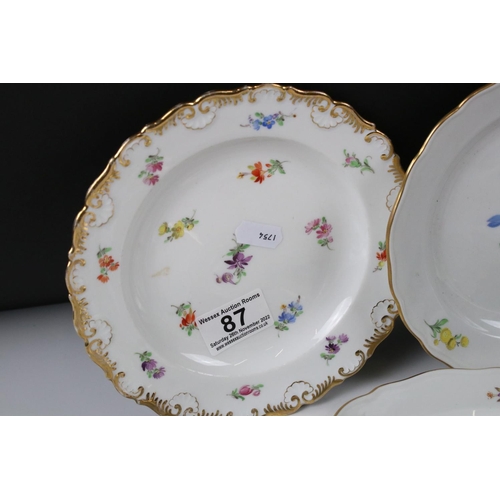 87 - Set of Four Meissen Porcelain Plates, each with a different hand painted floral design and gilt edge... 