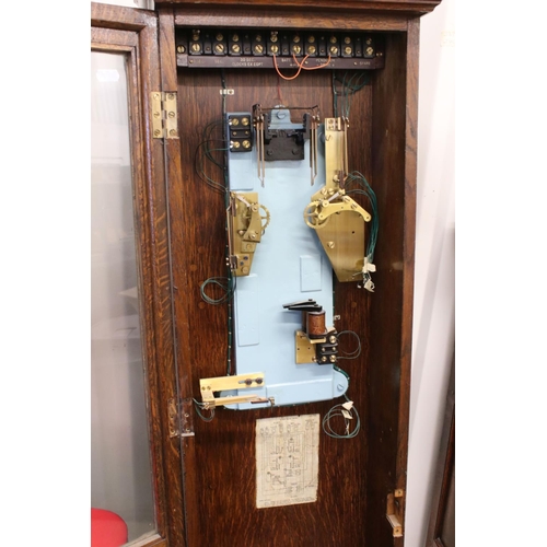 131A - PO36 Post Office Master Clock within an Oak Glazed Case, with pendulum and accessories including key... 