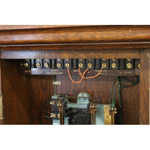 131A - PO36 Post Office Master Clock within an Oak Glazed Case, with pendulum and accessories including key... 