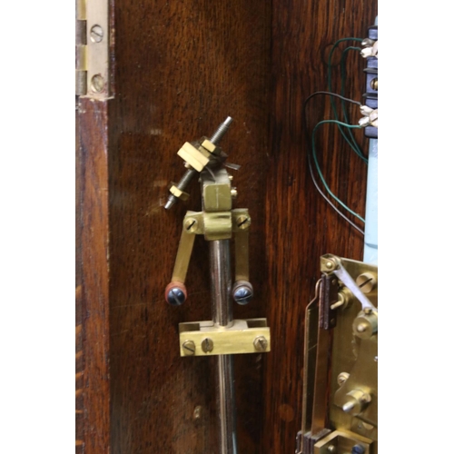 131A - PO36 Post Office Master Clock within an Oak Glazed Case, with pendulum and accessories including key... 