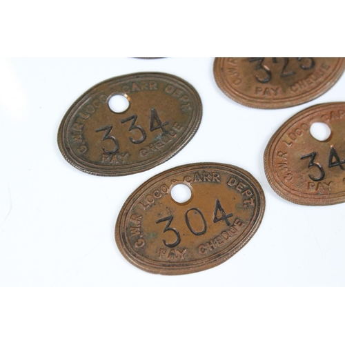 193 - A collection of five GWR / Great Western Railways pay cheque tokens.