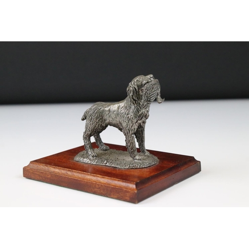 204 - Metal figurine of a gun dog carrying a pheasant, on a wooden base