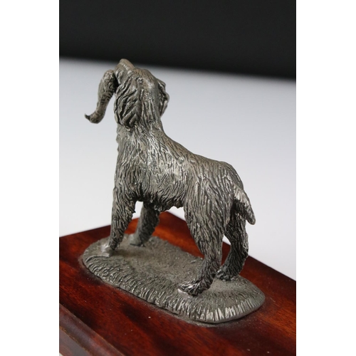 204 - Metal figurine of a gun dog carrying a pheasant, on a wooden base