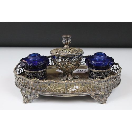 207 - A silver plated pierced decorated standish double ink will with blue glass wells.