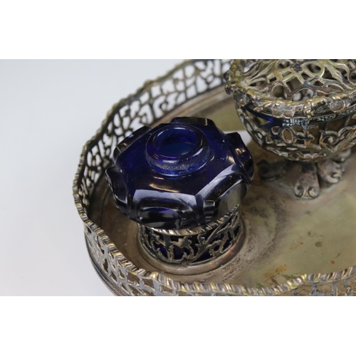 207 - A silver plated pierced decorated standish double ink will with blue glass wells.