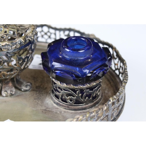 207 - A silver plated pierced decorated standish double ink will with blue glass wells.