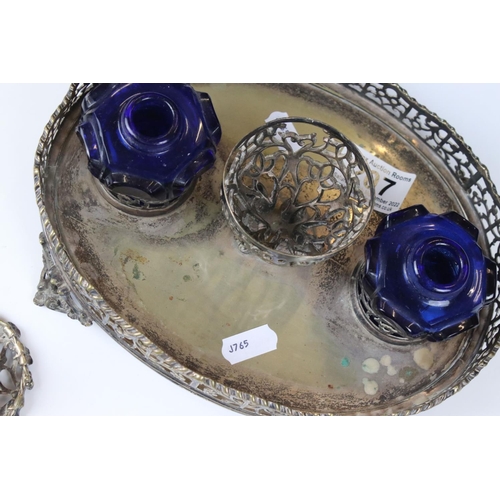 207 - A silver plated pierced decorated standish double ink will with blue glass wells.