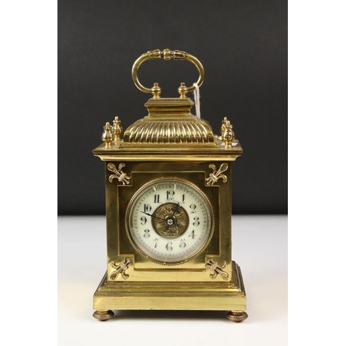 215 - An antique brass cased carriage clock with Fluer De Lis decoration, marked for Lund & Blockley of Lo... 