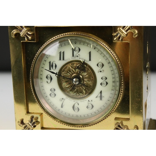 215 - An antique brass cased carriage clock with Fluer De Lis decoration, marked for Lund & Blockley of Lo... 