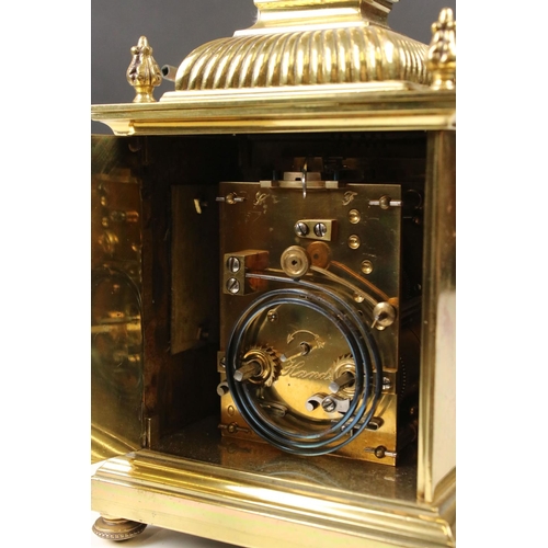 215 - An antique brass cased carriage clock with Fluer De Lis decoration, marked for Lund & Blockley of Lo... 