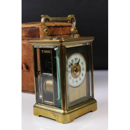 231 - A French made brass cased carriage clock with bevelled glass panels, repeater function button to top... 