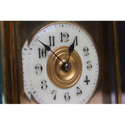 231 - A French made brass cased carriage clock with bevelled glass panels, repeater function button to top... 