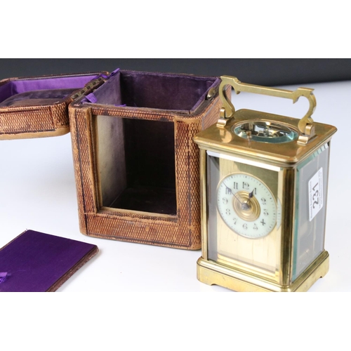 231 - A French made brass cased carriage clock with bevelled glass panels, repeater function button to top... 