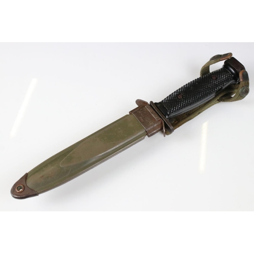 239 - A United State Korean War era M5 bayonet complete with scabbard and frog.