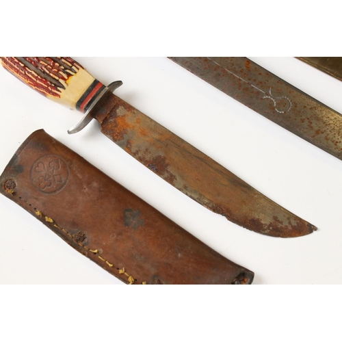 240 - A vintage scouting / sheath knife in leather scabbard together with an asian knife in brass scabbard... 