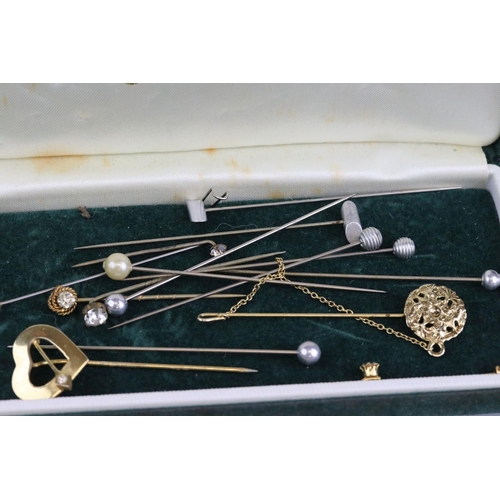 275 - A small collection of tie / cravat pins to include yellow metal and a lucite example.