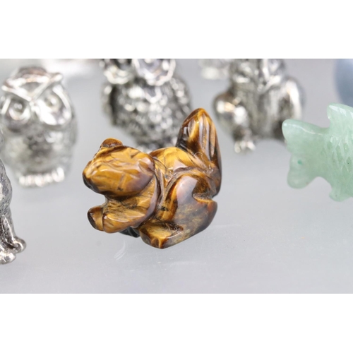 279 - A collection of miniature animal figures to include white metal and stone examples.