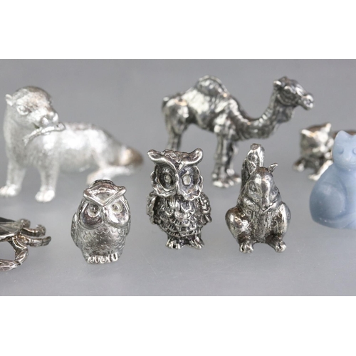 279 - A collection of miniature animal figures to include white metal and stone examples.