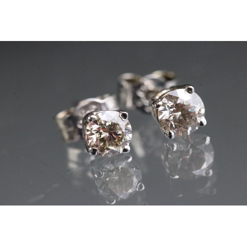 281 - Pair of 14ct white gold diamond stud earrings of 65 points total