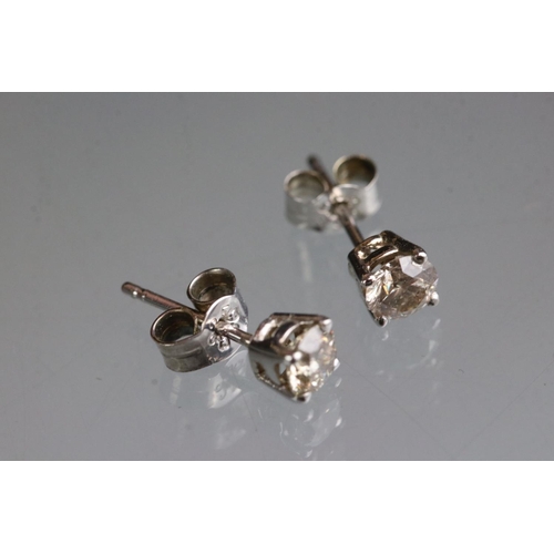 281 - Pair of 14ct white gold diamond stud earrings of 65 points total