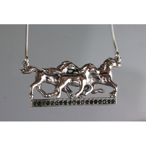 282 - Silver galloping horse pendant necklace on sapphire set platform