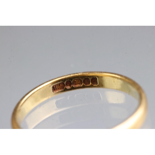 284 - A fully hallmarked 22ct gold wedding band together with a yellow metal signet ring.