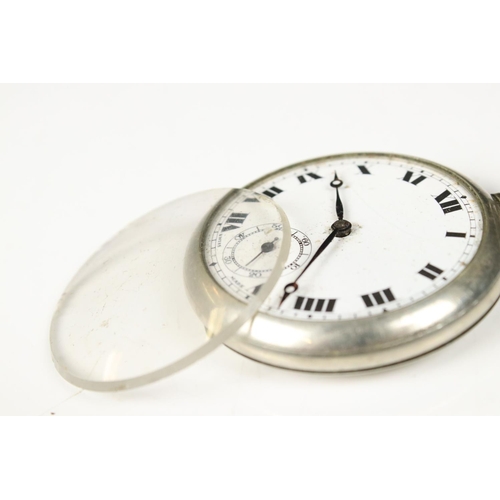 309 - A vintage top winding pocket watch in white metal case with sub second dial to 6 o'clock.