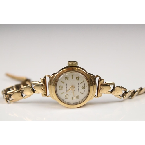 313 - A ladies Ingersol wristwatch set into a 9ct gold case with 9ct gold strap together with a similar 9c... 