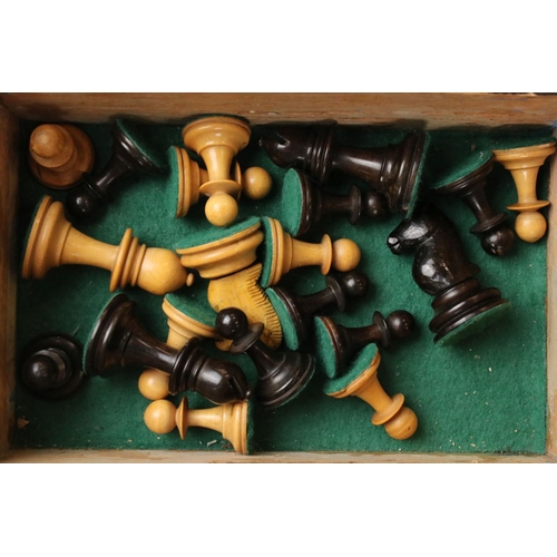 329 - A wooden chess set, in the style of Staunton, within a wooden box together with a wooden chess board... 