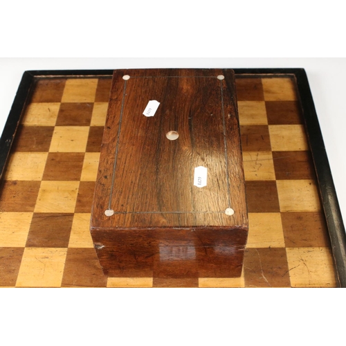 329 - A wooden chess set, in the style of Staunton, within a wooden box together with a wooden chess board... 