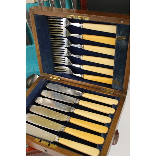 332 - Two wooden cased sets of cutlery to include a fish knife and fork set.