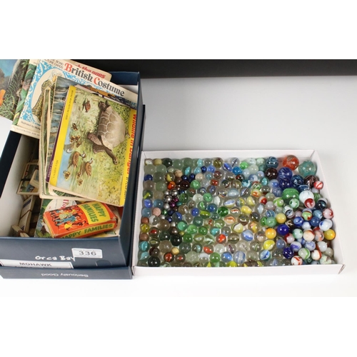 336 - A small box of mixed collectables to include marbles, tea cards to include loose and mounted example... 