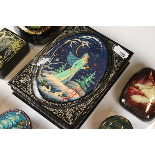 342 - A collection of nine Russian lacquerware trinket boxes with traditional decorative scenes.