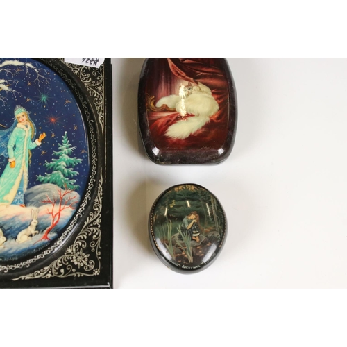 342 - A collection of nine Russian lacquerware trinket boxes with traditional decorative scenes.