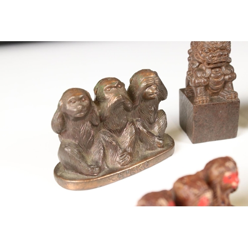 344 - A small collection of ornamental figures to include the three wise monkeys, foo dogs and Buddha head... 