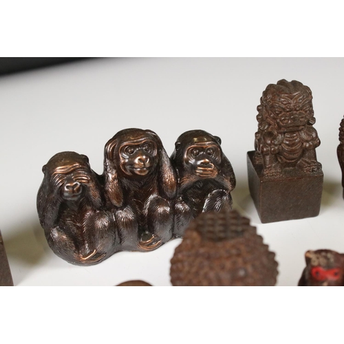 344 - A small collection of ornamental figures to include the three wise monkeys, foo dogs and Buddha head... 