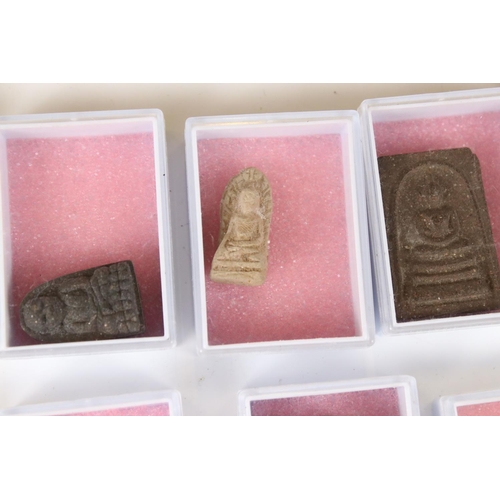 351 - A large collection of Thai budhist amulets contained within individual display boxes.